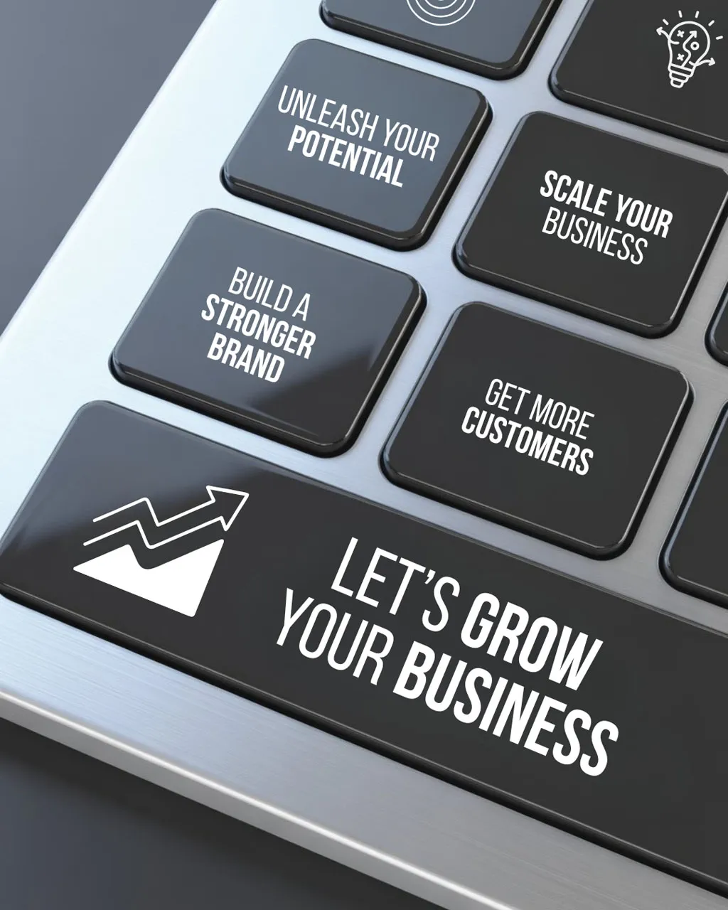 Close-up of a computer keyboard with custom business growth keys.